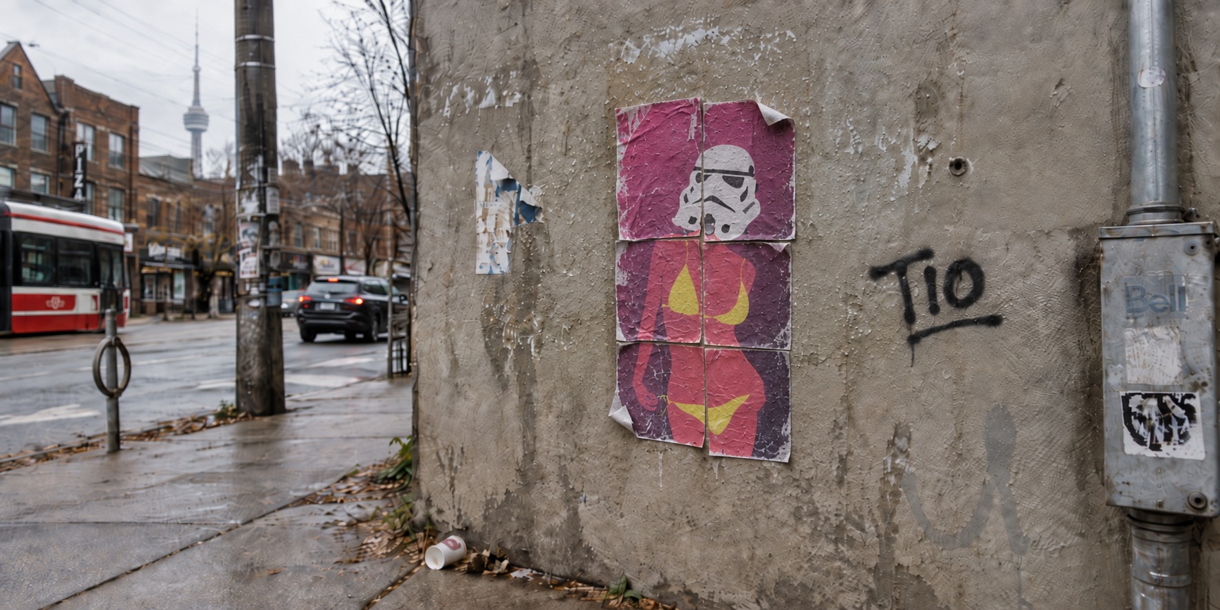 A TORON10 artist poster pasted onto plywood hoarding.