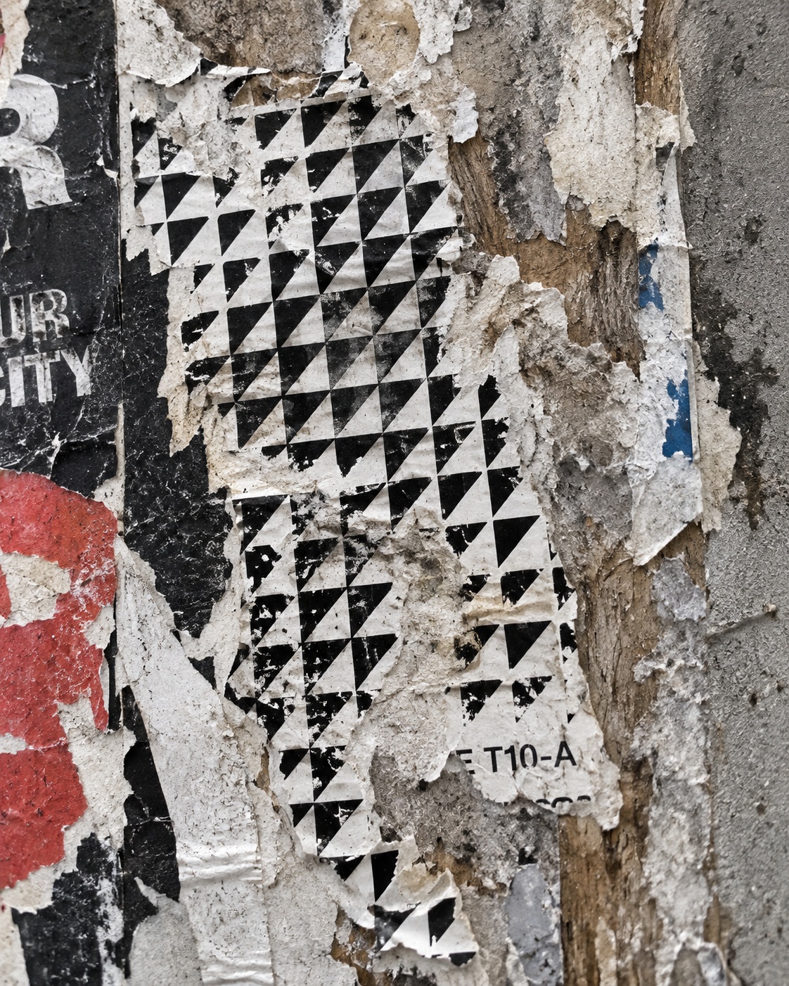 Torn paper layers with part of a TORON10 artist code still visible.