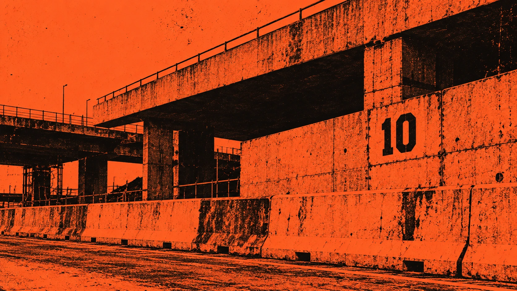 Orange and black rail corridor running beneath a concrete overpass